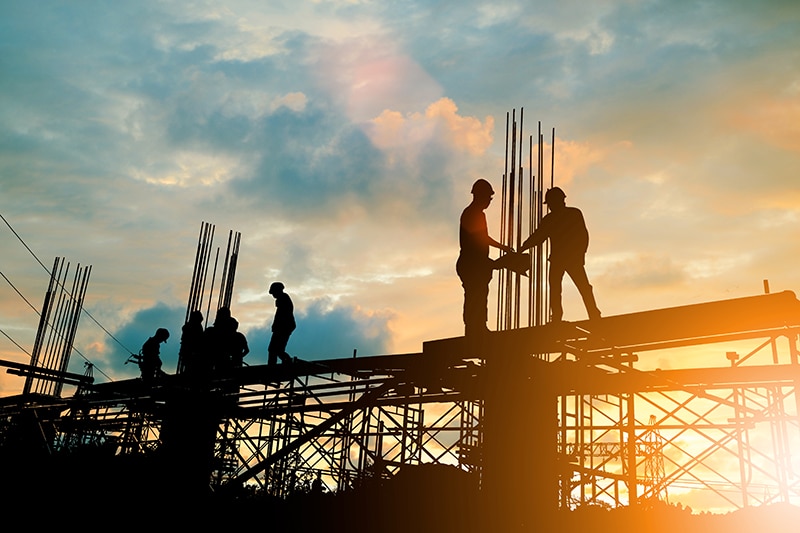 Cetan Funds provides funding for Commercial Construction Silhouette of engineer and construction team working at site