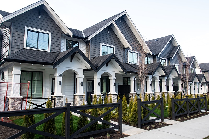 Townhomes or Condominiums Exterior Photo of white and grey Townhomes